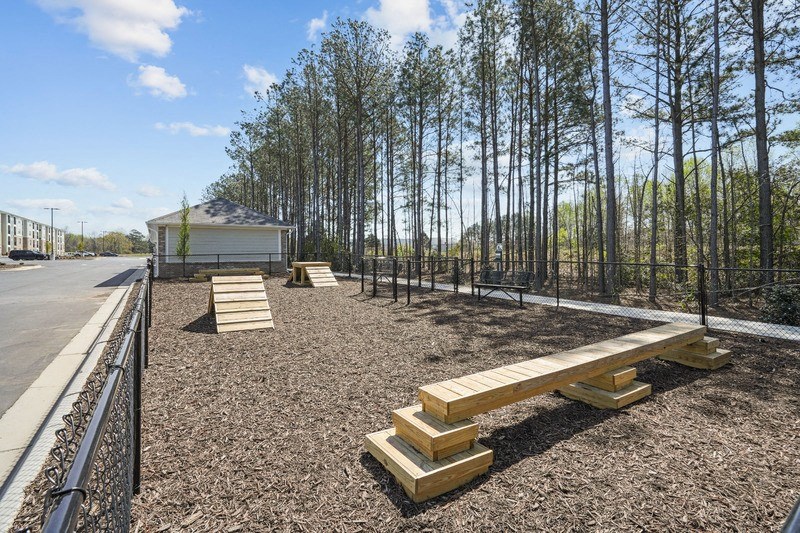 a dog park with benches and fence