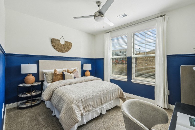 a bedroom with a bed and a ceiling fan