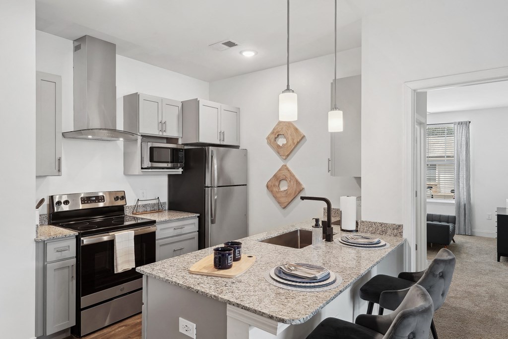 a kitchen with granite counter tops and stainless steel appliances