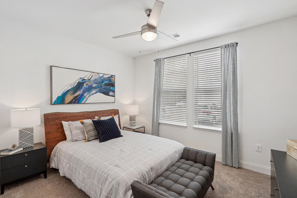 a bedroom with a bed and a large window