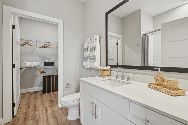 A bathroom with a white sink and a mirror.