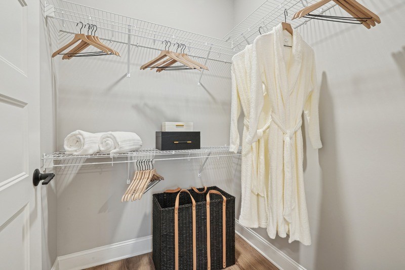 A white robe is hanging on a clothes rack.