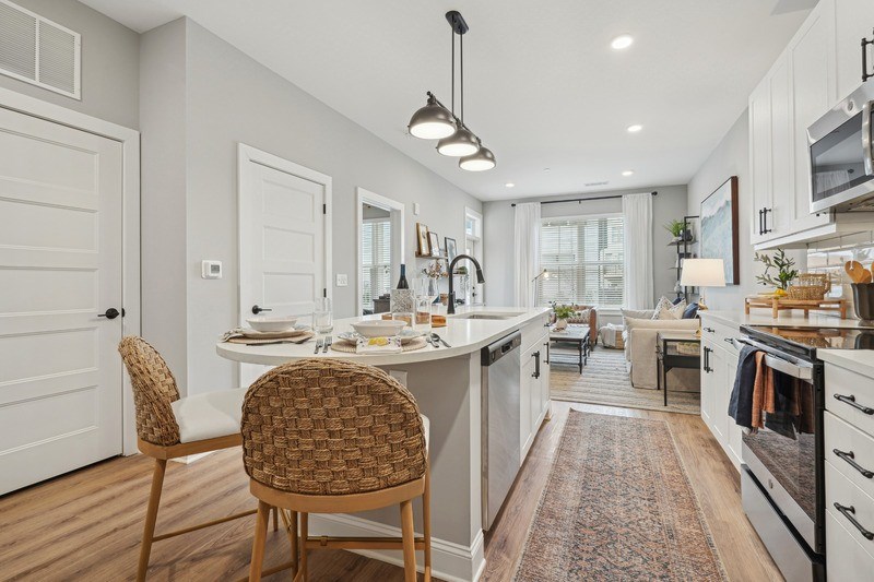 A kitchen with a dining table and chairs.