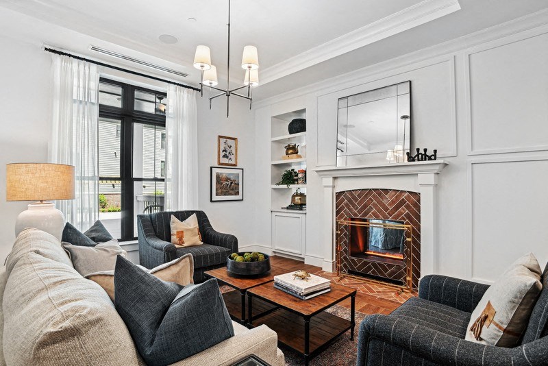 a living room with couches and chairs and a fireplace