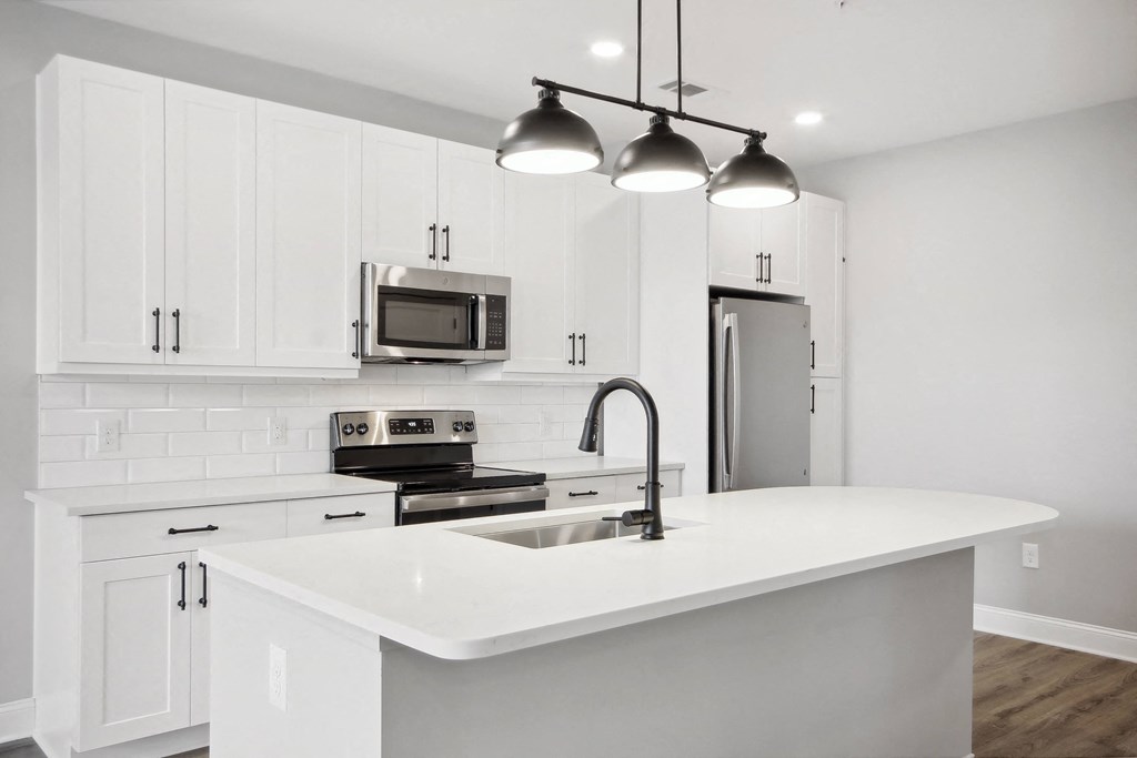 a kitchen with white cabinets and a white counter top