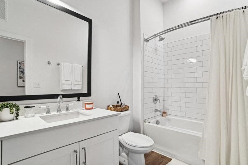 A white bathroom with a sink, toilet, and bathtub.