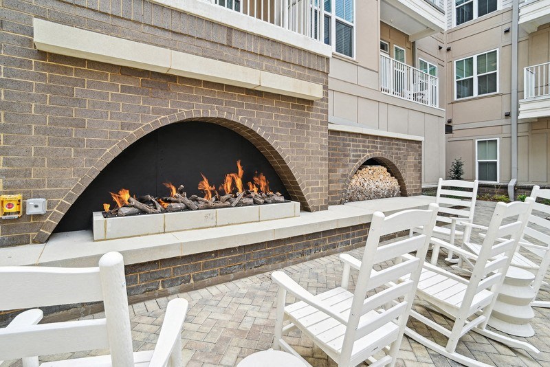 Firepit with white rocking chairs around it