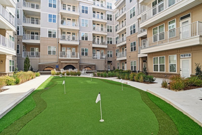 a putting green in the middle of an apartment building