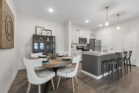 A modern kitchen with a dining table and chairs.
