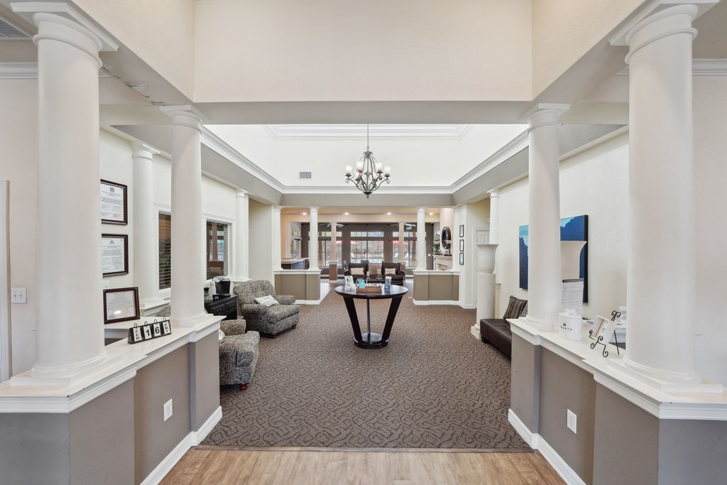 a large room with pillars and a table in the middle