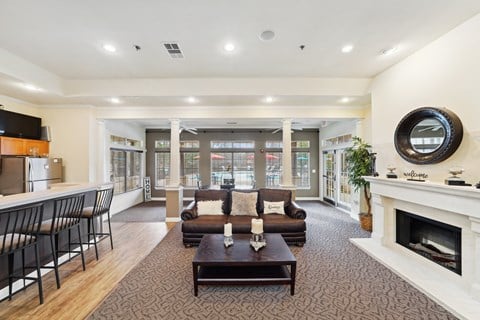 a living room with a couch and a coffee table and a fireplace