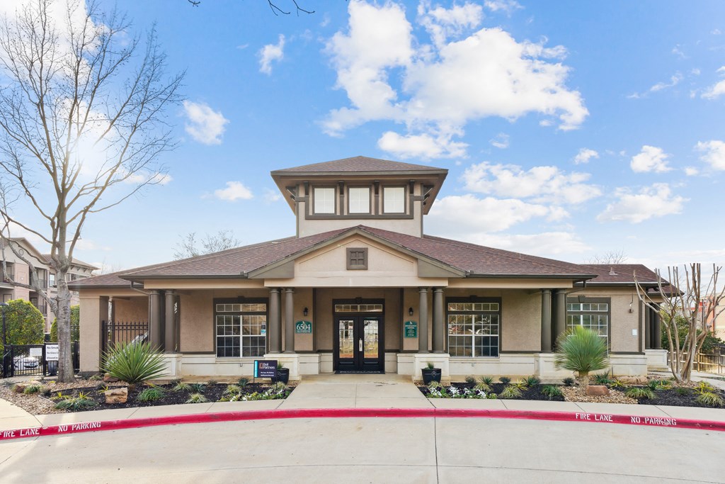 the front entrance of a building with a red curb