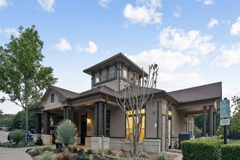 the front of a building with a clock on the side of it