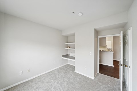 a bedroom with a closet and a door to a bathroom