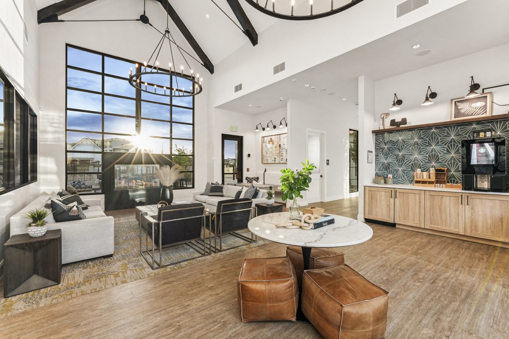 a living room with couches and a table and a large window