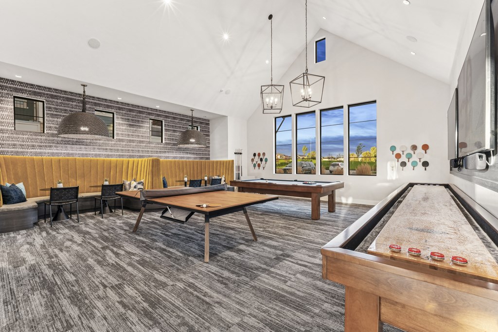 a game room with tables and ping pong