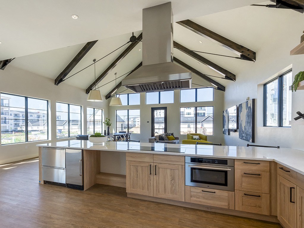 a large kitchen with a large center island and a large range above it