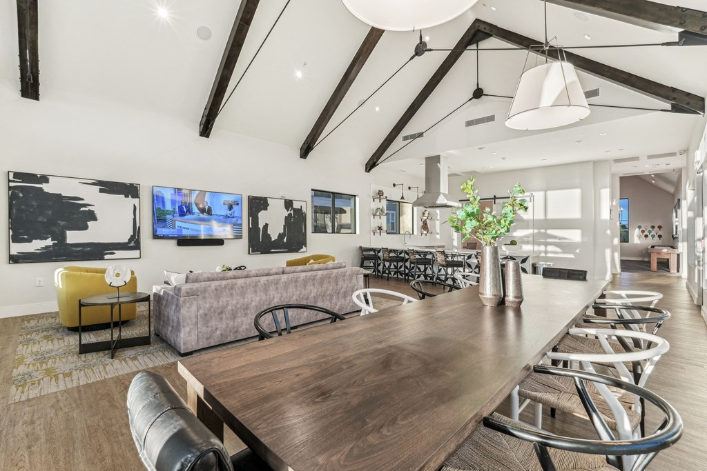 a living room with a long wooden table and chairs
