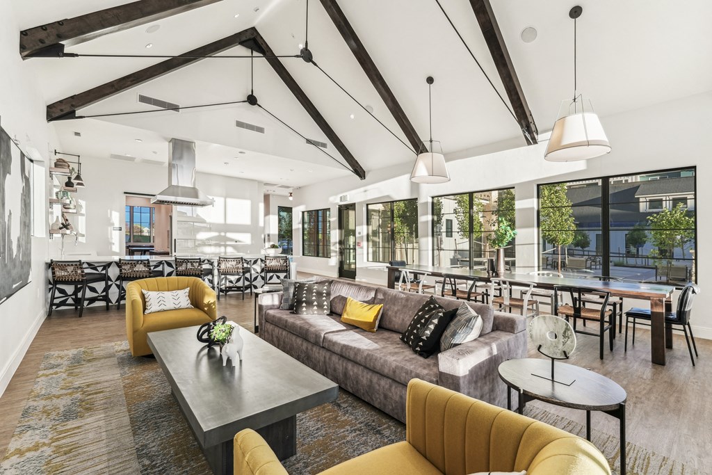 a large living room with couches and chairs and tables