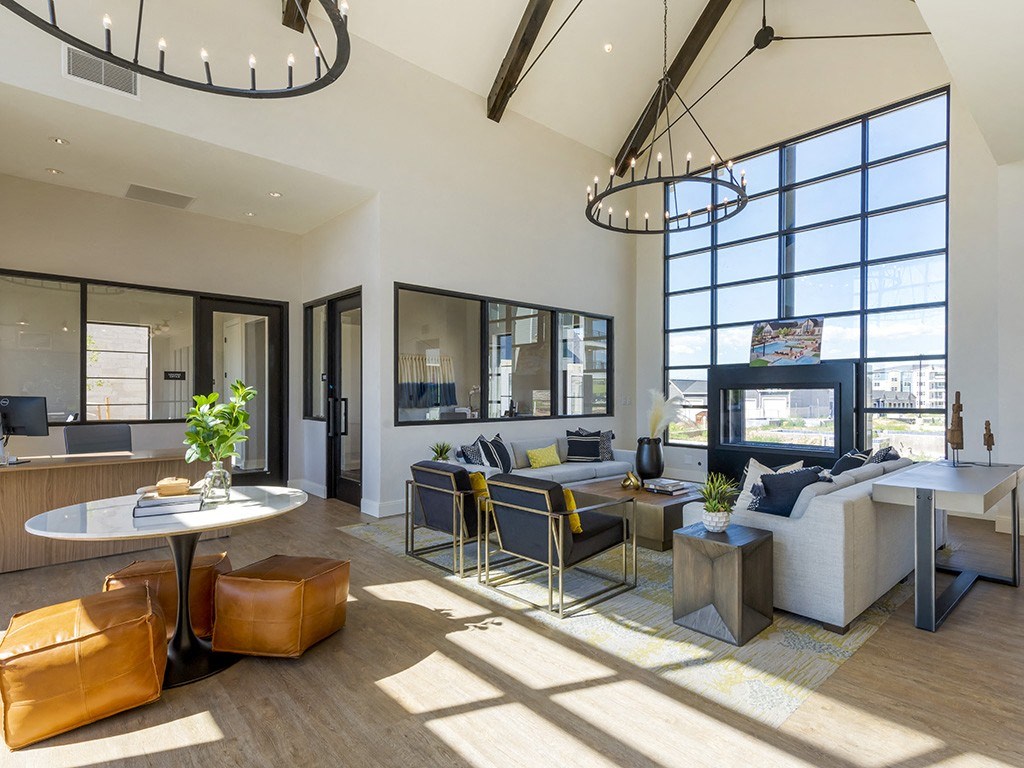 a living room with couches and chairs and a fireplace