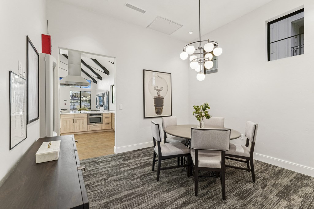 a dining room with a table and chairs and a kitchen