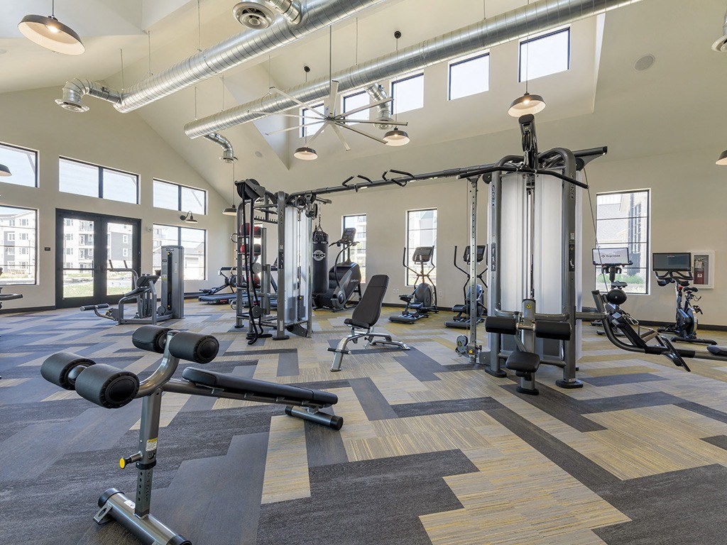 a gym with weights and other exercise equipment at the flats