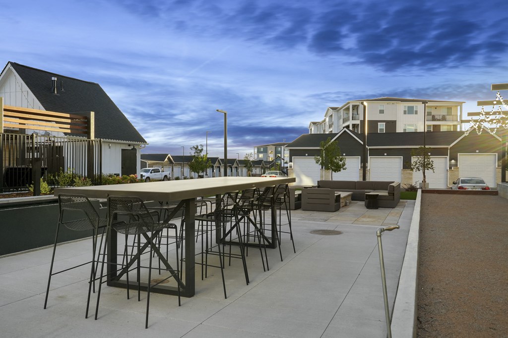 an outdoor bar with chairs and tables on a patio