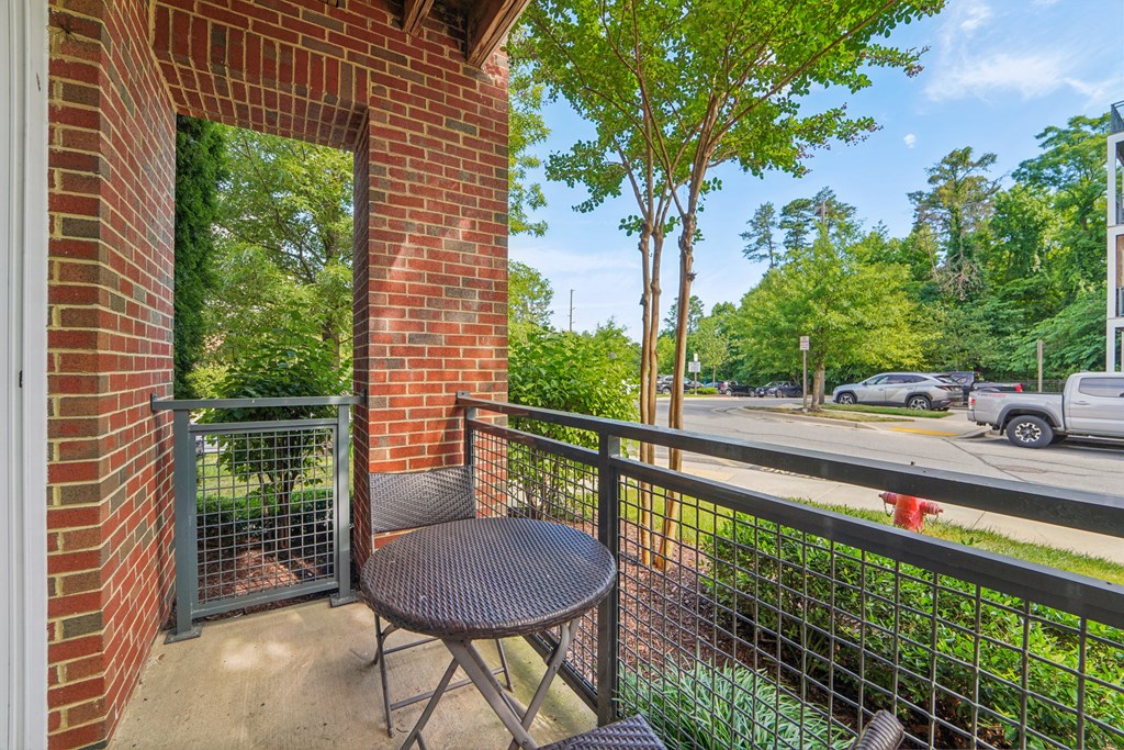 a patio with a table and chairs on a balcony