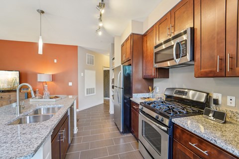 a kitchen with stainless steel appliances and granite counter tops
