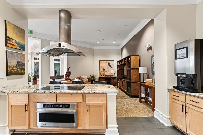 A modern kitchen with wooden cabinets and a large island.