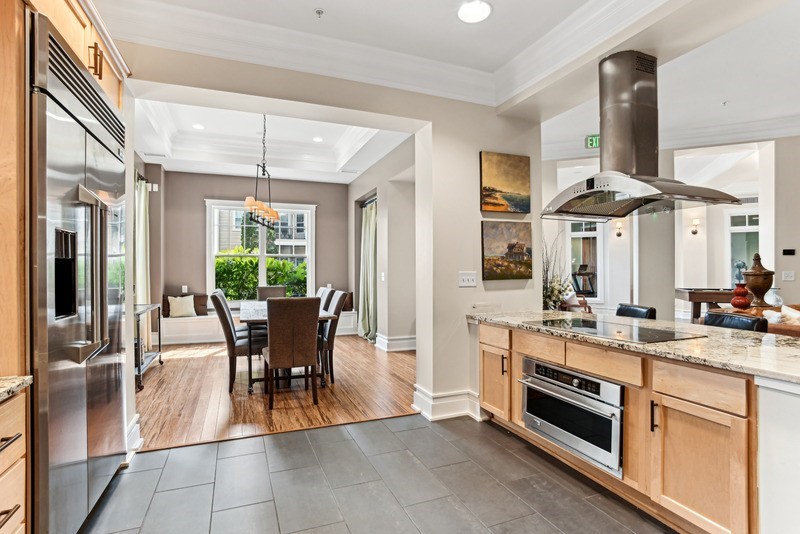 A modern kitchen with a dining table and chairs.