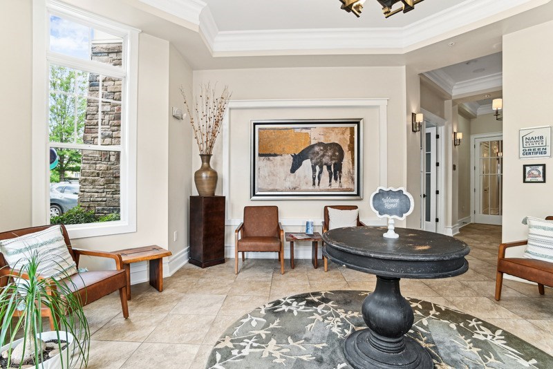A living room with a large painting of a moose on the wall.