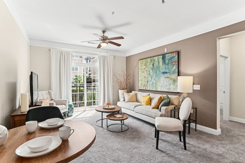 A living room with a sofa, chairs, and a dining table.