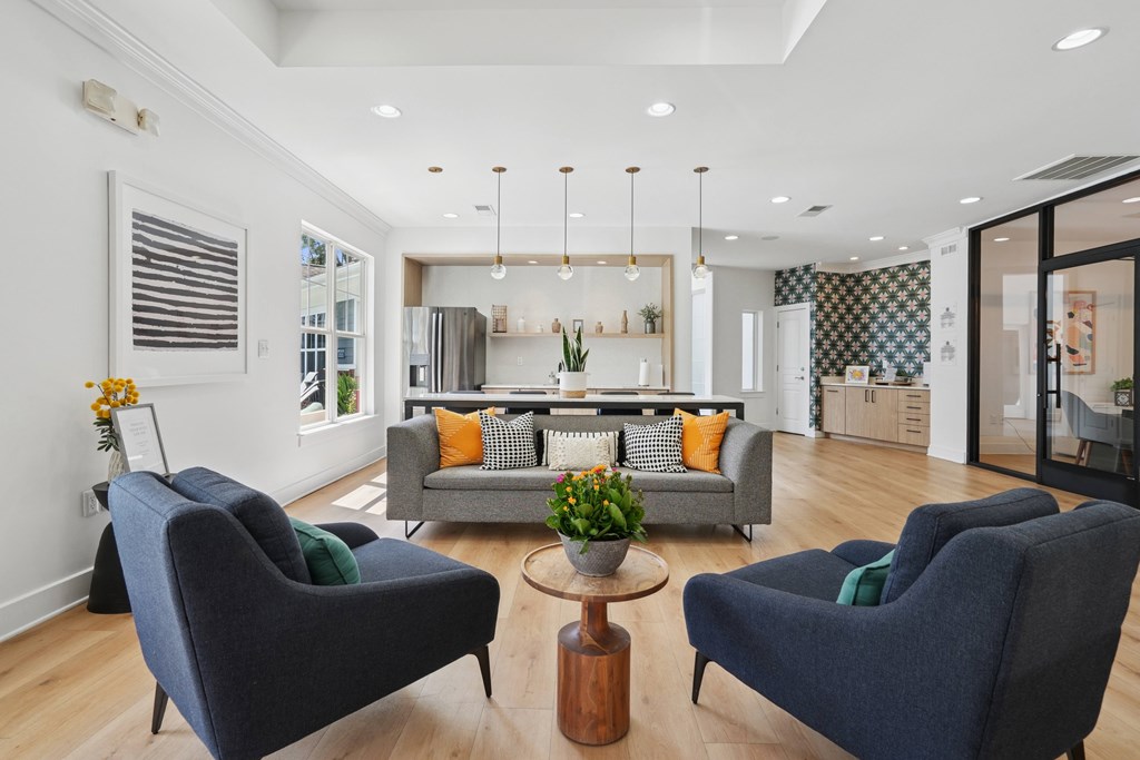 A living room with a grey sofa, two matching chairs and a coffee table.