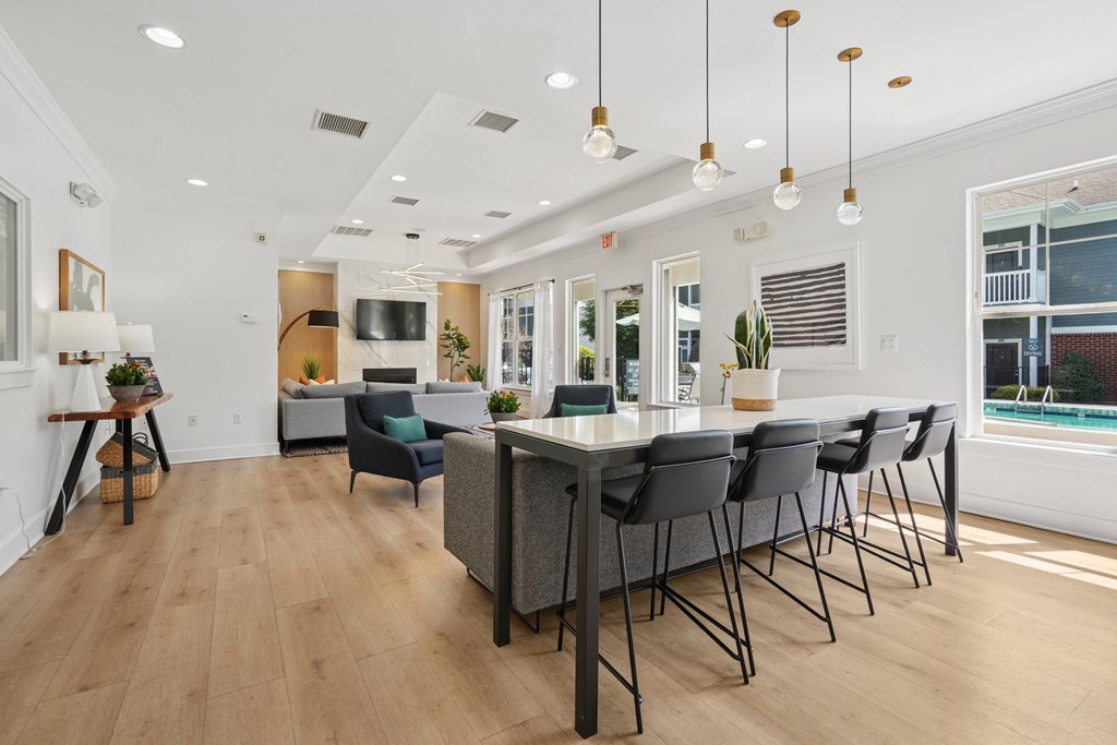 A modern dining room with a long table and chairs.