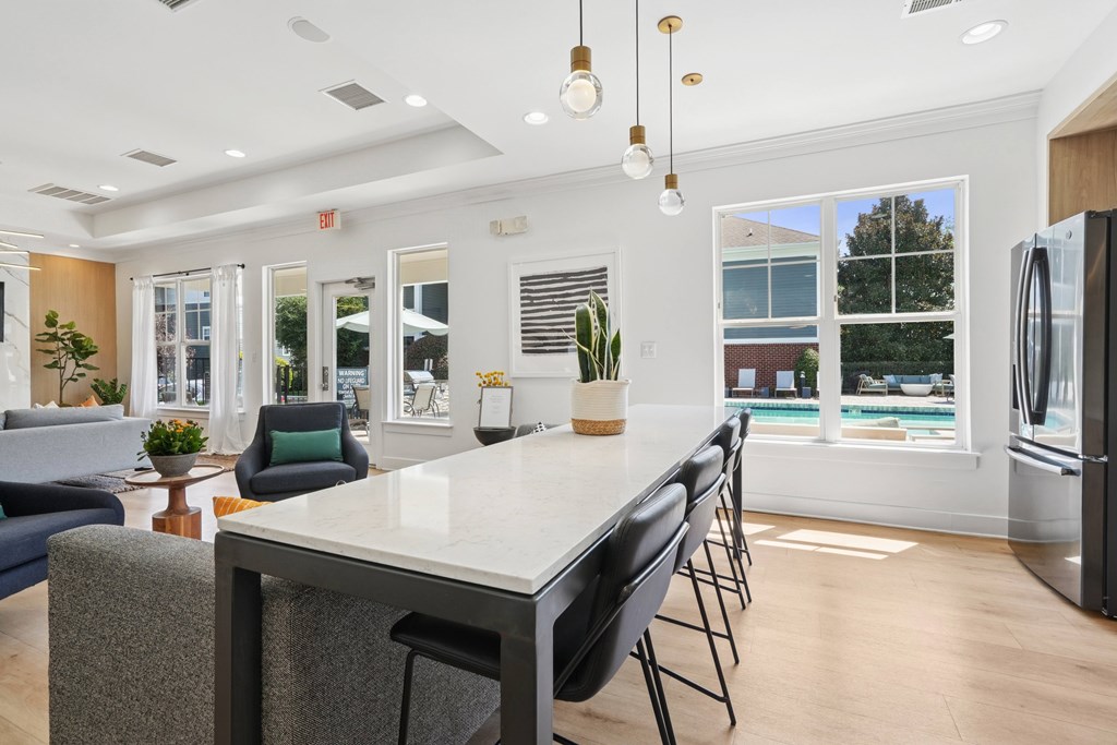 A modern kitchen with a dining table and chairs.