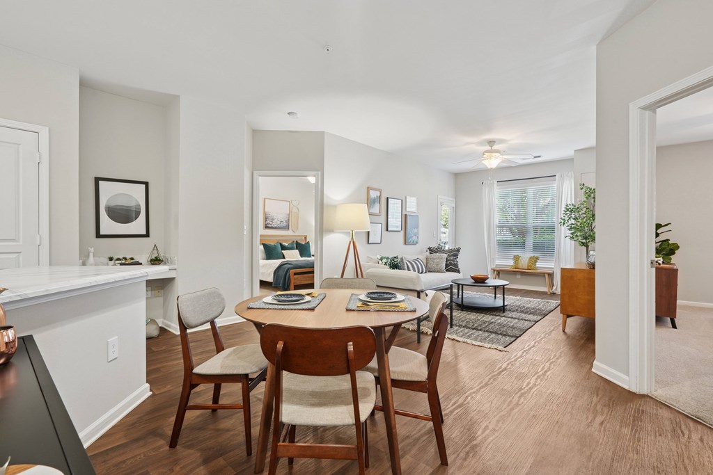 A dining room with a wooden table and chairs.