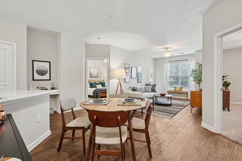 A dining room with a wooden table and chairs.