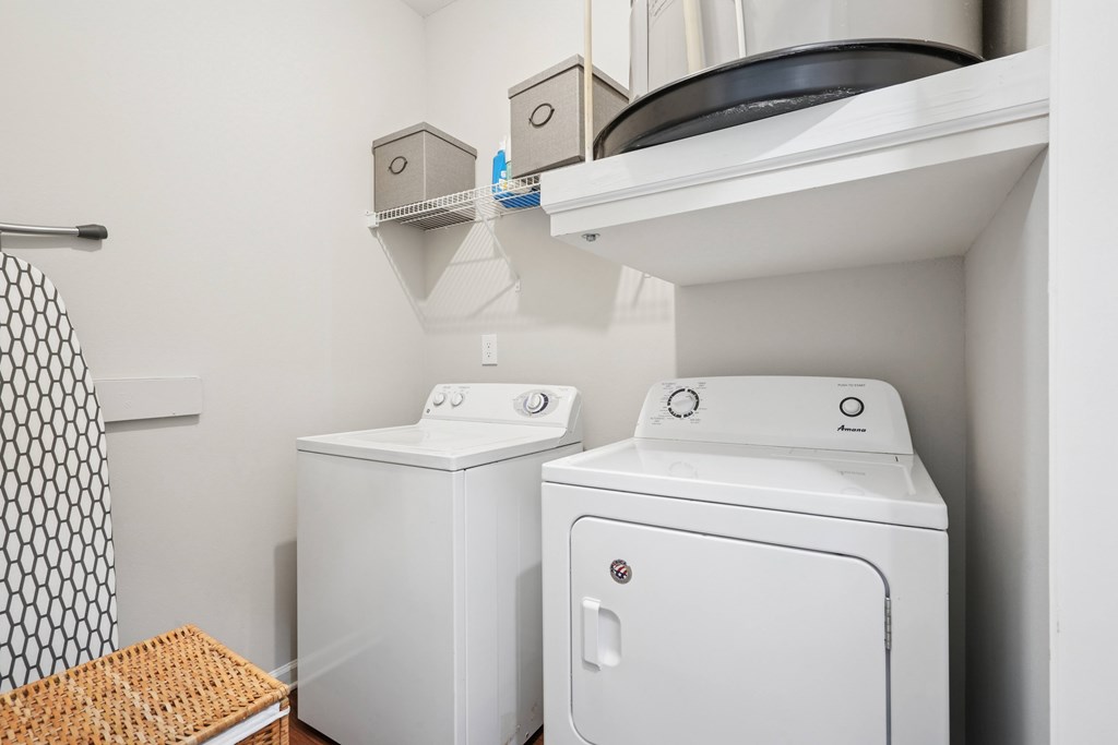 A small laundry room with a washer and dryer.