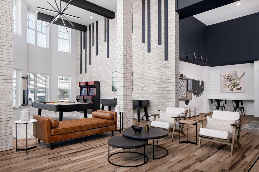 A living room with a brown couch and a black coffee table.