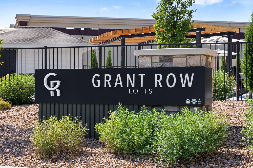 A sign for Grant Row Lofts is displayed in front of a building.