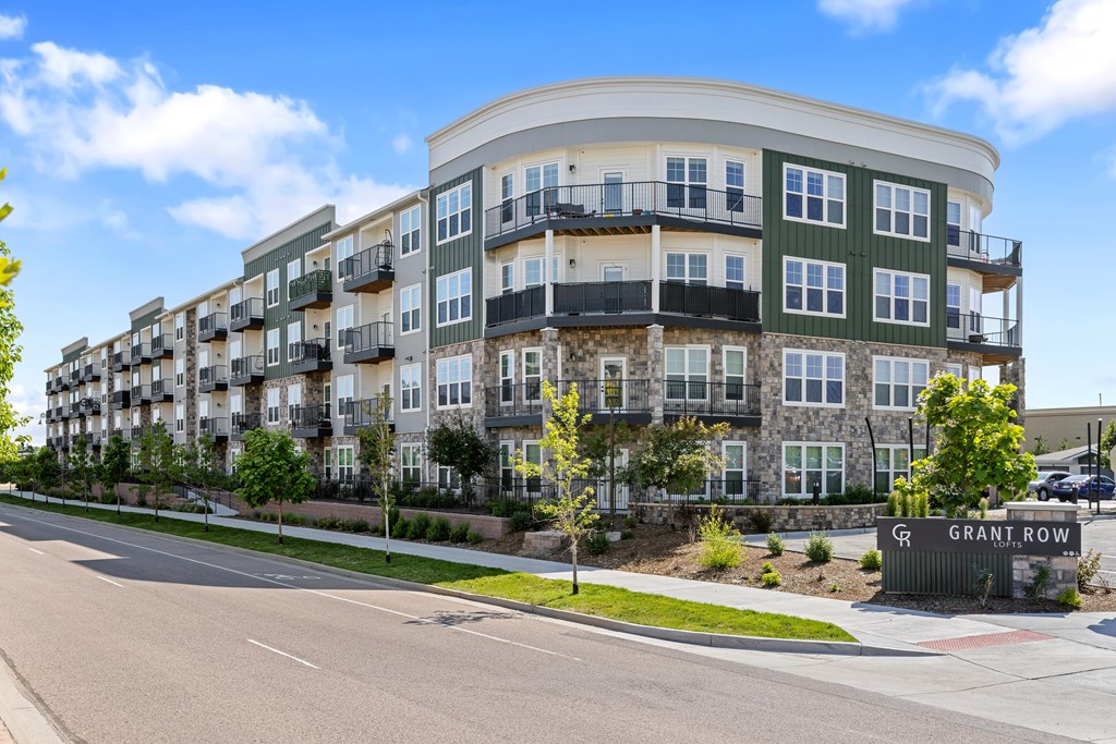 A street view of a multi-story building named Grant Row.