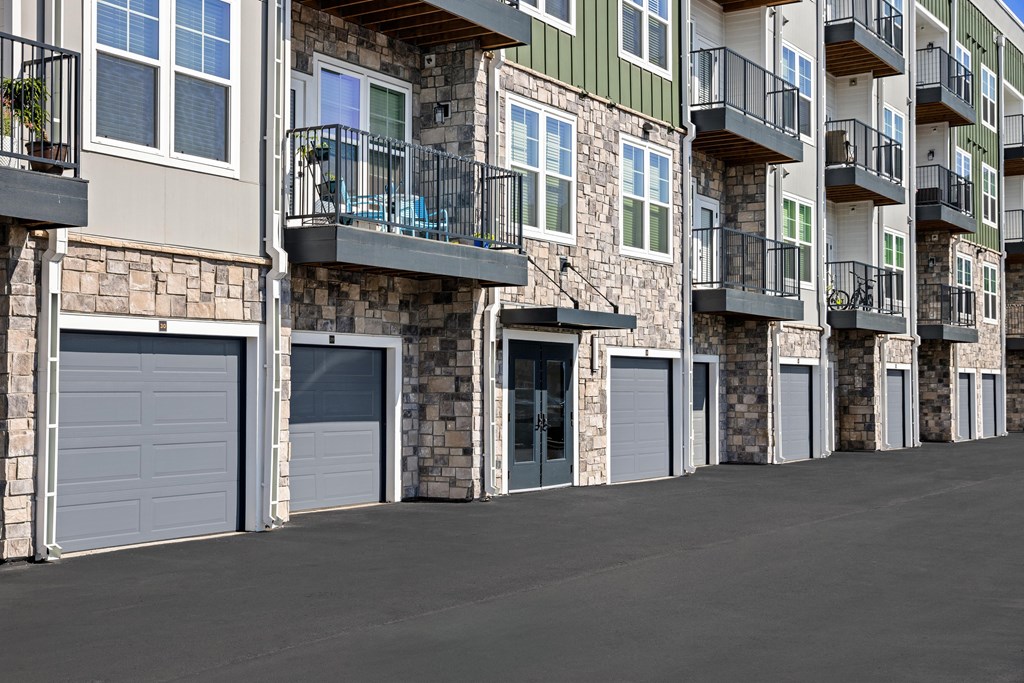Apartment building with balconies and garages.