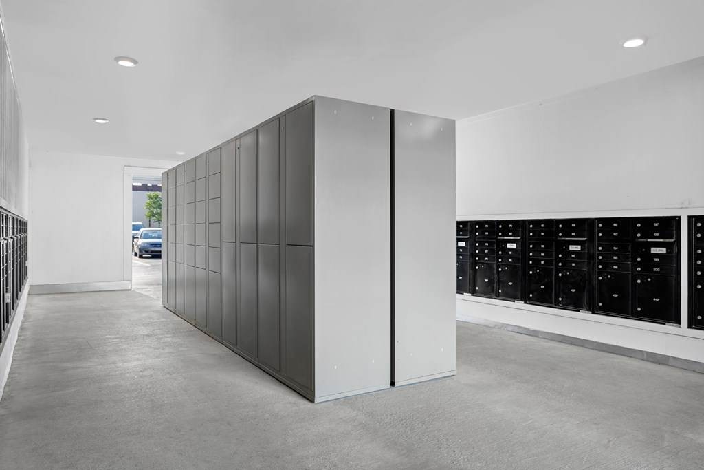 A modern room with a white wall and a black cabinet.