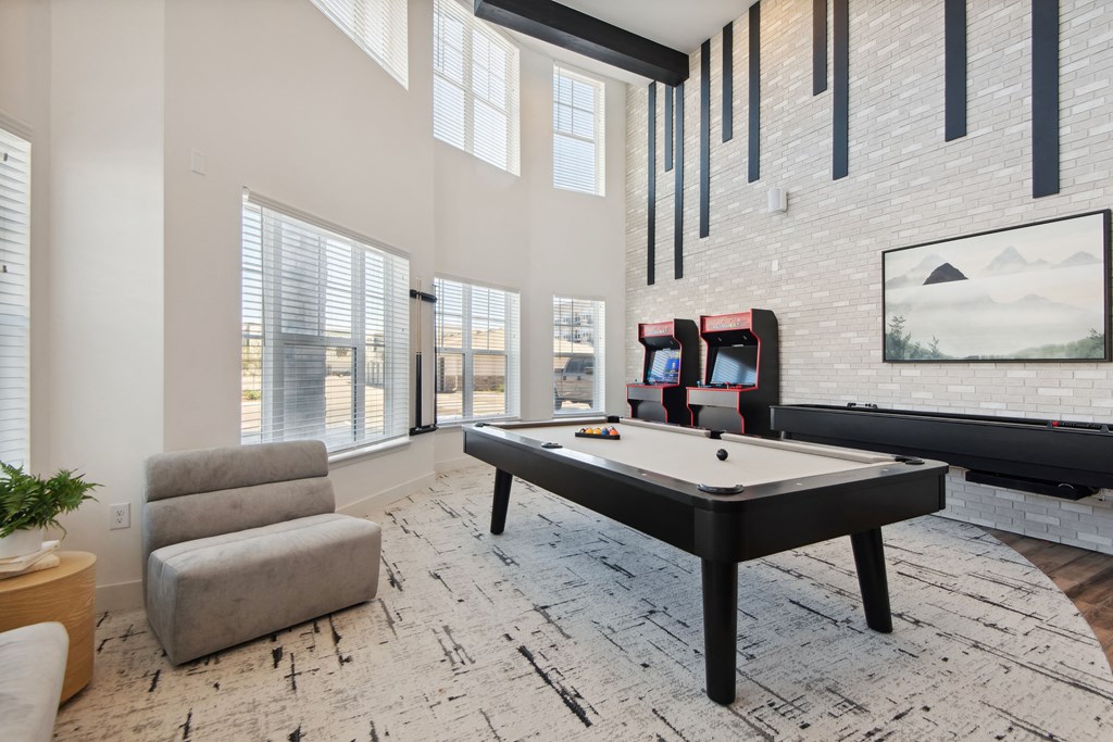 a games room with a pool table and a tv