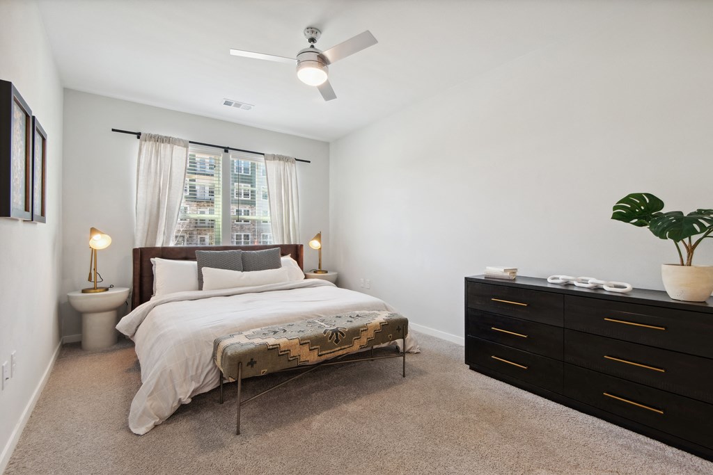 a bedroom with a bed and a dresser