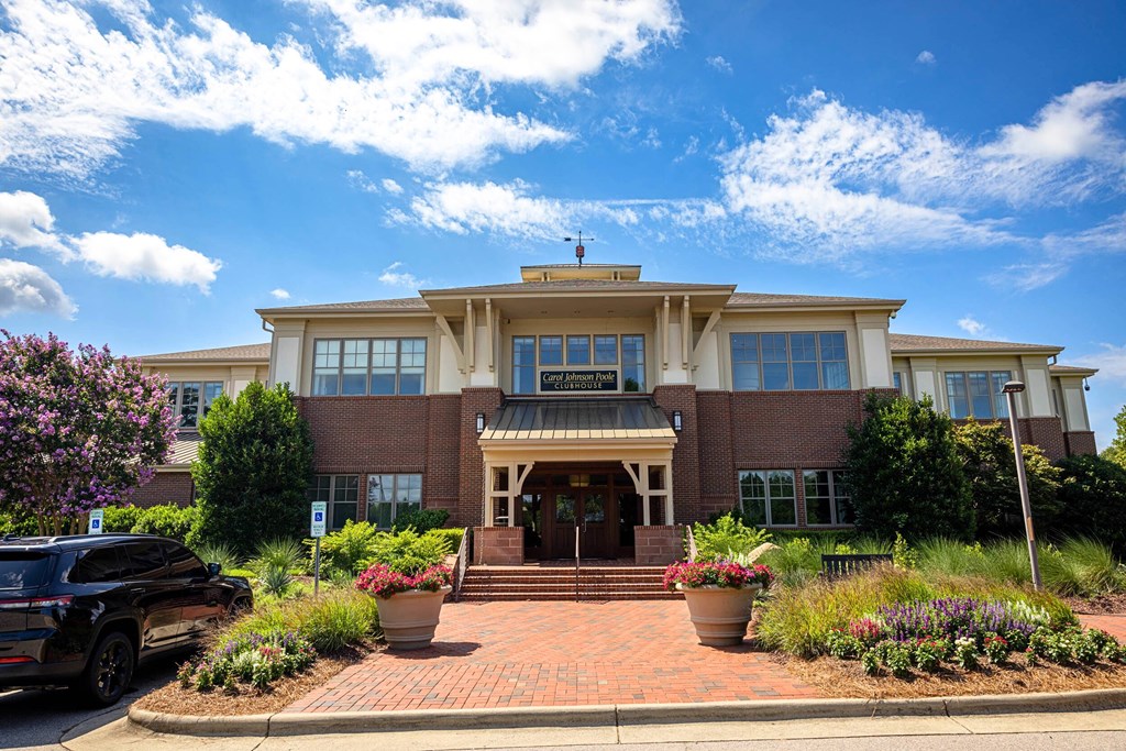 A large house with a brick walkway in front.