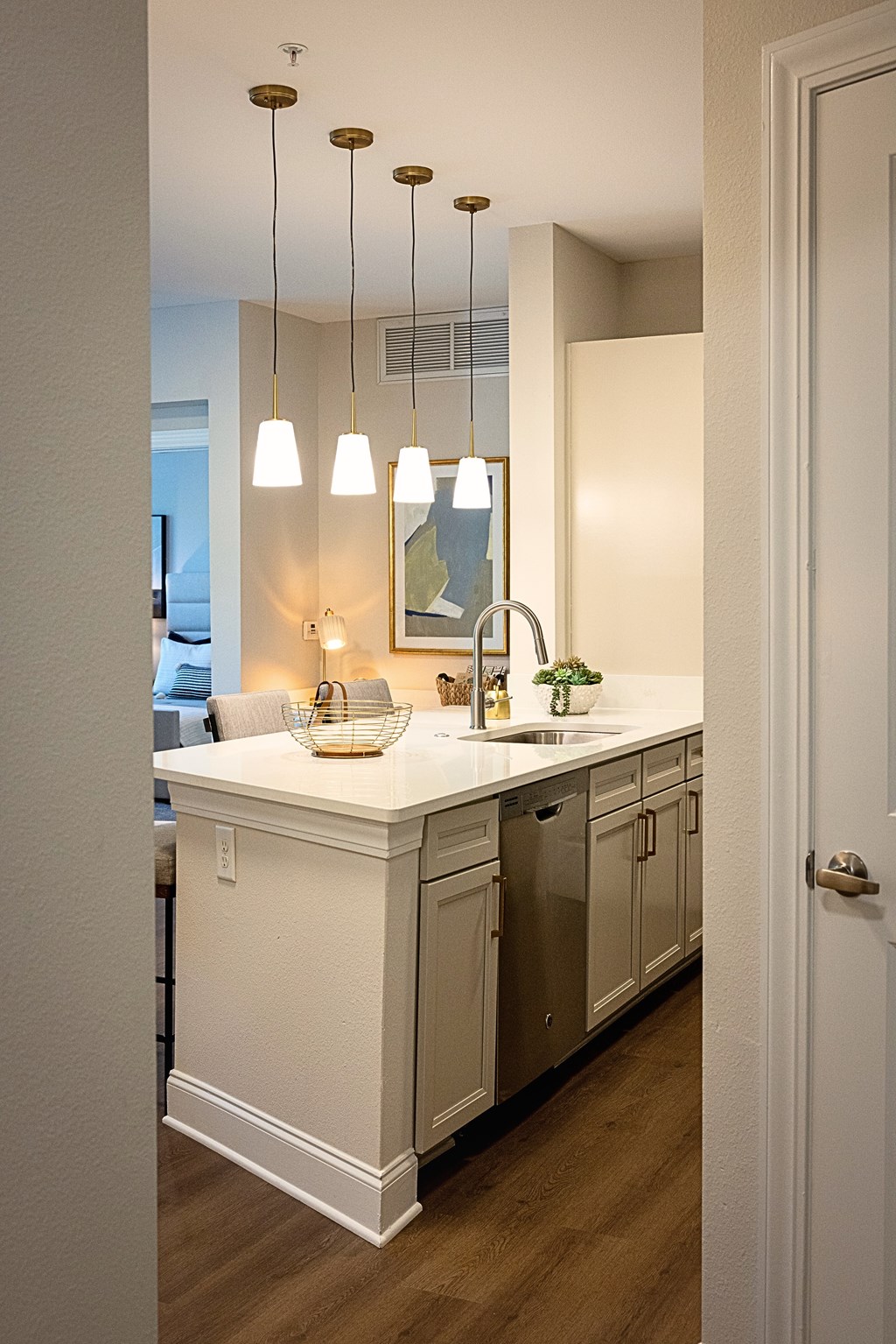 A kitchen with a white counter and a white door.