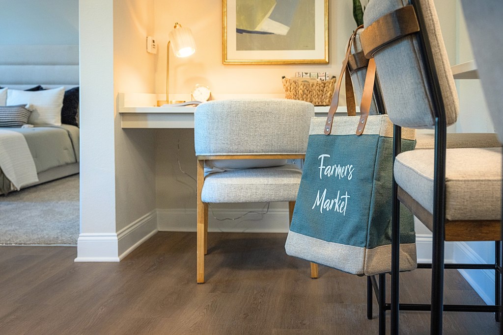 A chair with a bag that says Farmers Market is in the foreground.