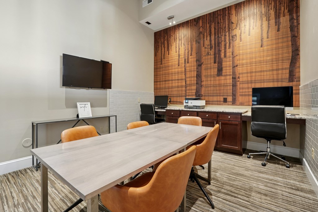 A conference room with a long table and chairs.